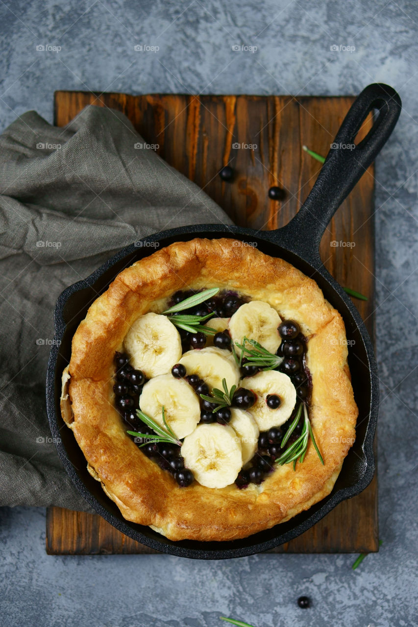 Dutch baby pancake with banana and black currant