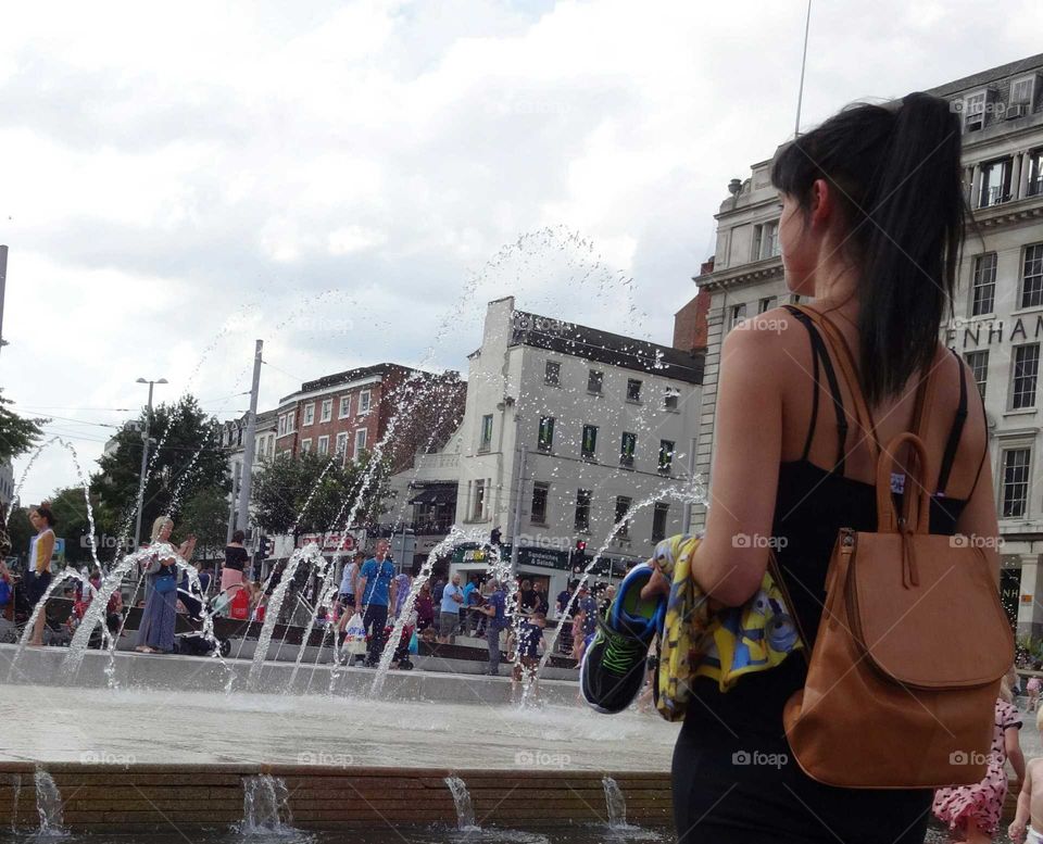 People cooling of in the fountains at Old Market Squar in city centre of Nottingham, England