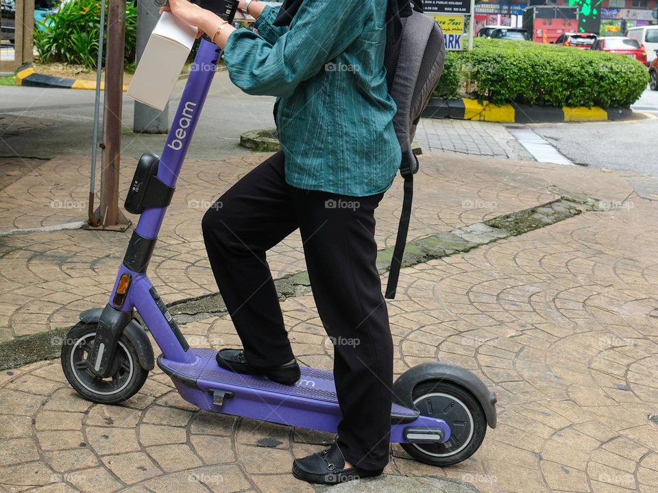 Trying the scooter in Kuala Lumpur, Malaysia
