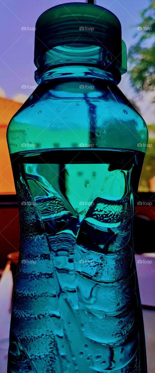 Water crystal clear chilled in green bottle