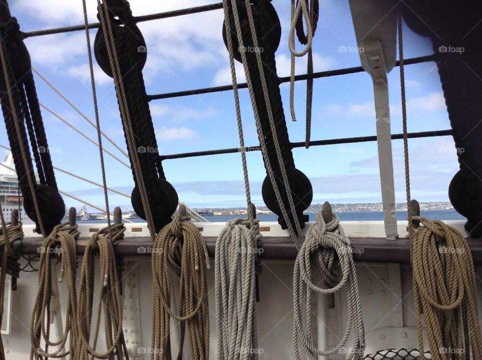 sail boat in San Diego, ropes hang ready, lets set sail, blue skies