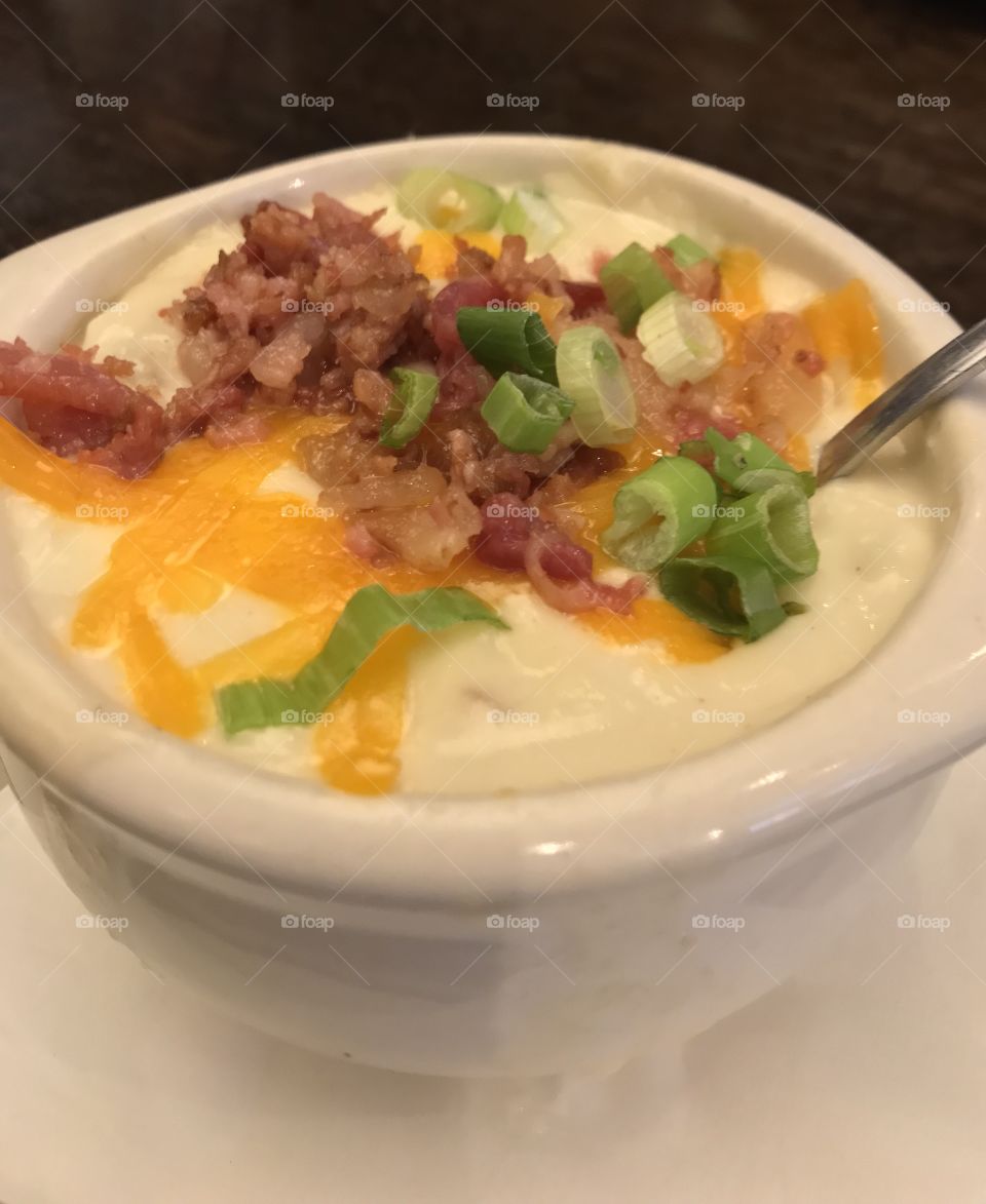 Loaded potato soup with cheese, bacon, and scallions 