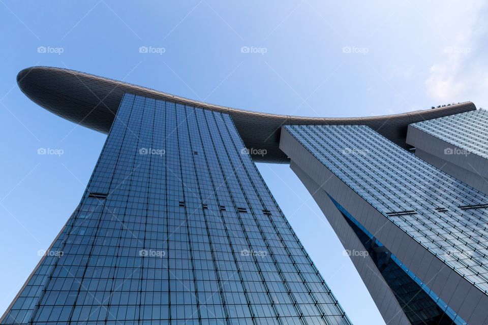 Looking up Marina Bay Sands. Looking up Marina Bay Sands building in Singapore. Blue sky and cloud in the background. Day time. Famous building. 