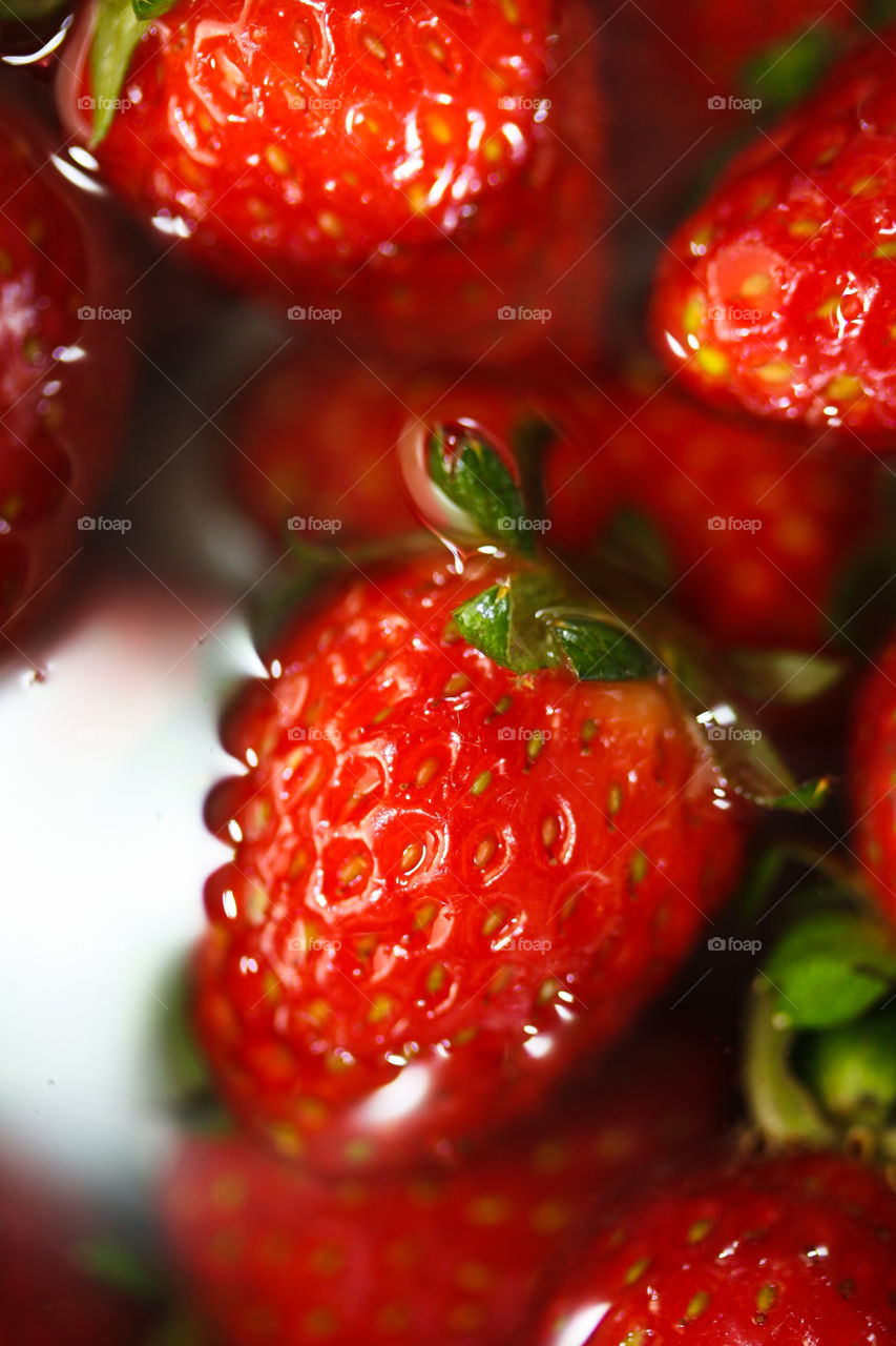 Washing ripe red strawberries