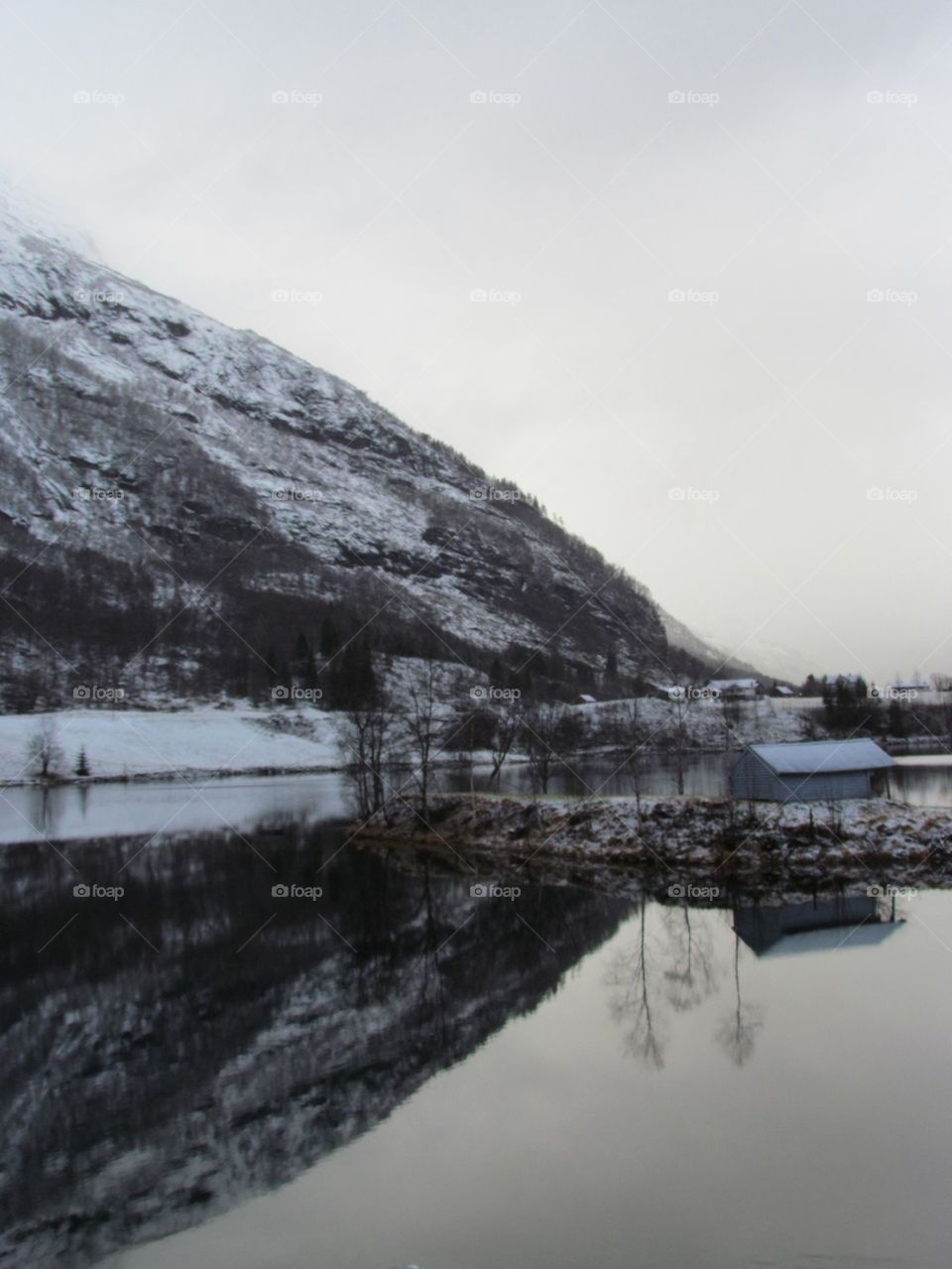 Mountain. Winter. Snow. Reflection. River. Water. Grey. Cold.