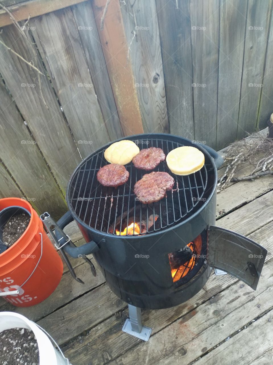 A photo of me grilling burgers on my back deck, remember, any sunny day can be made better with a home barbeque