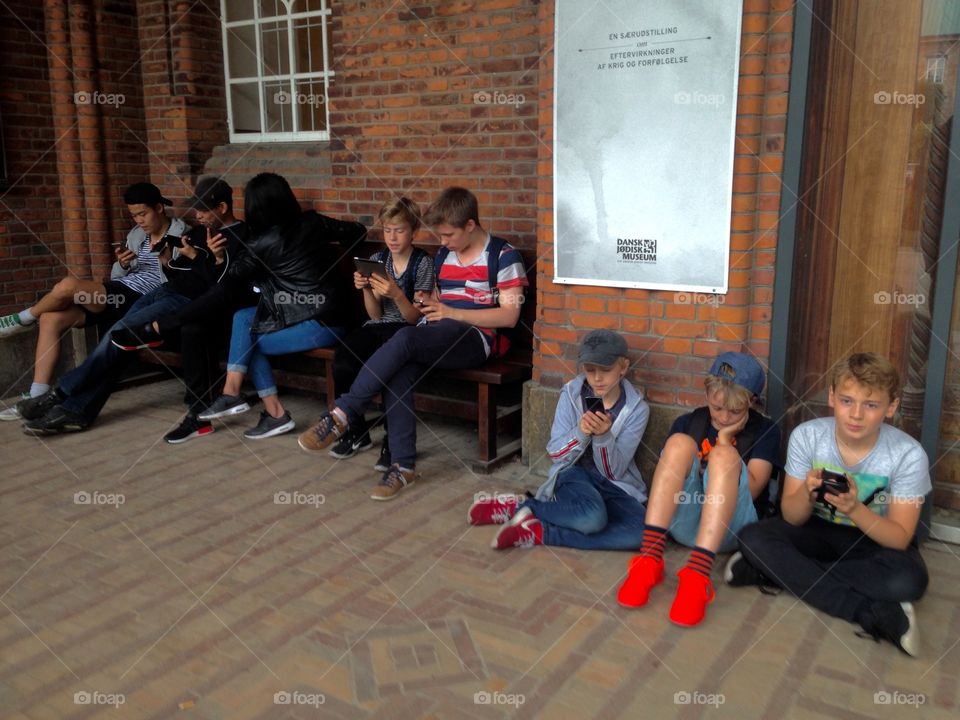 Copenhagen, Sweden, Groups Swedish children playing Pokemon Go smart phone game together