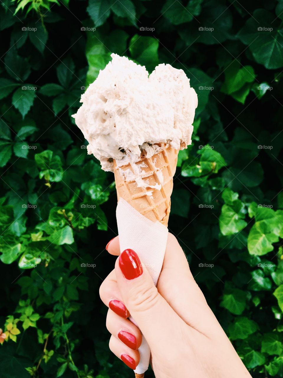 Woman hand holding ice cream cone