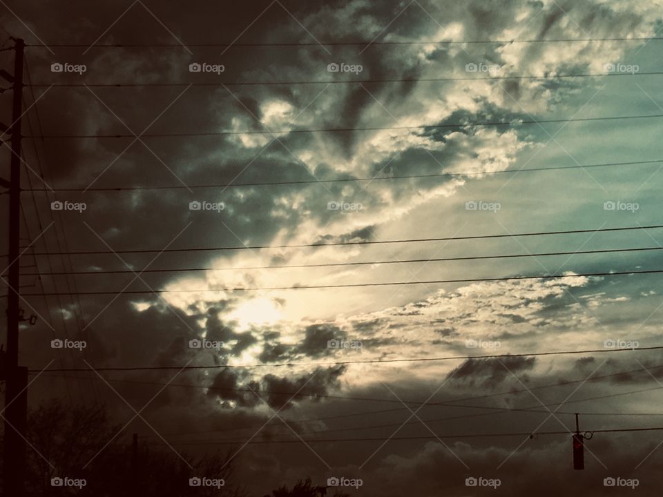 Dramatic clouds with powerlines looks like a harp