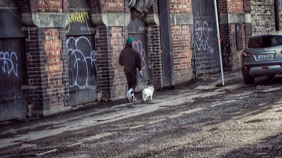 Man in black hoodie walk with dog around the Gunness store