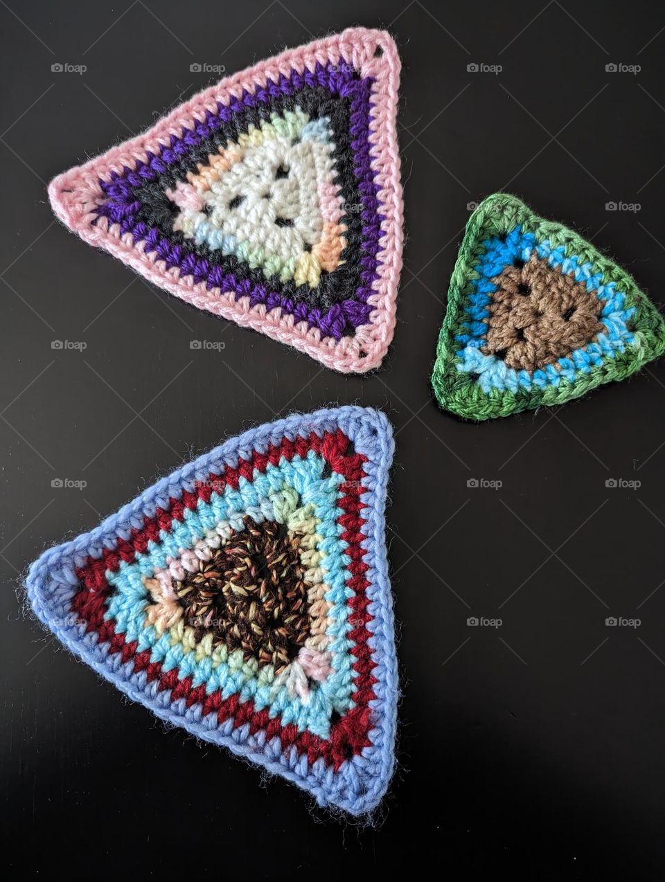 I am still a rather novice when it comes to crocheting. I am making triangle granny squares using scrap yarn to make a blanket.