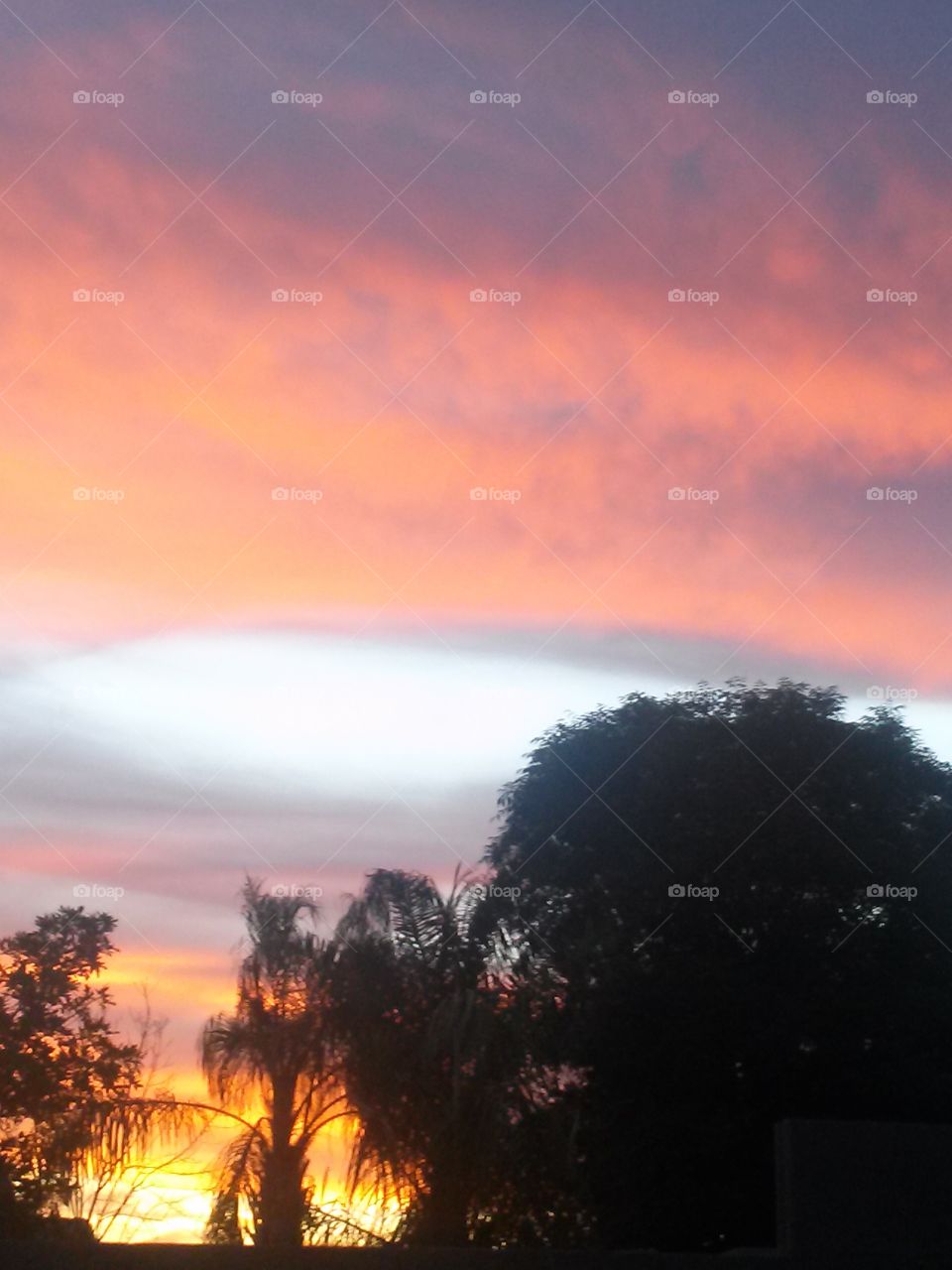 Beautiful sunset with colors that glow, God the Artist , sure puts 
on a Great Art Show .
And it is free to All, no charge 
of money, how coomom that is 
To sit outside. Me and my Honey
And see spectacular skies
With my Baby and I 
And the best part of it all,
I can photograph the Lovely site
And show one and all
The Beautiful Sunset , I was so
Fortunate to see one night.