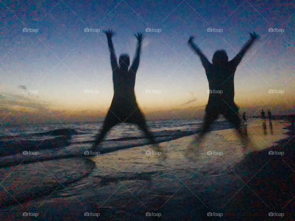 Silhouettes Jumping on the Beach