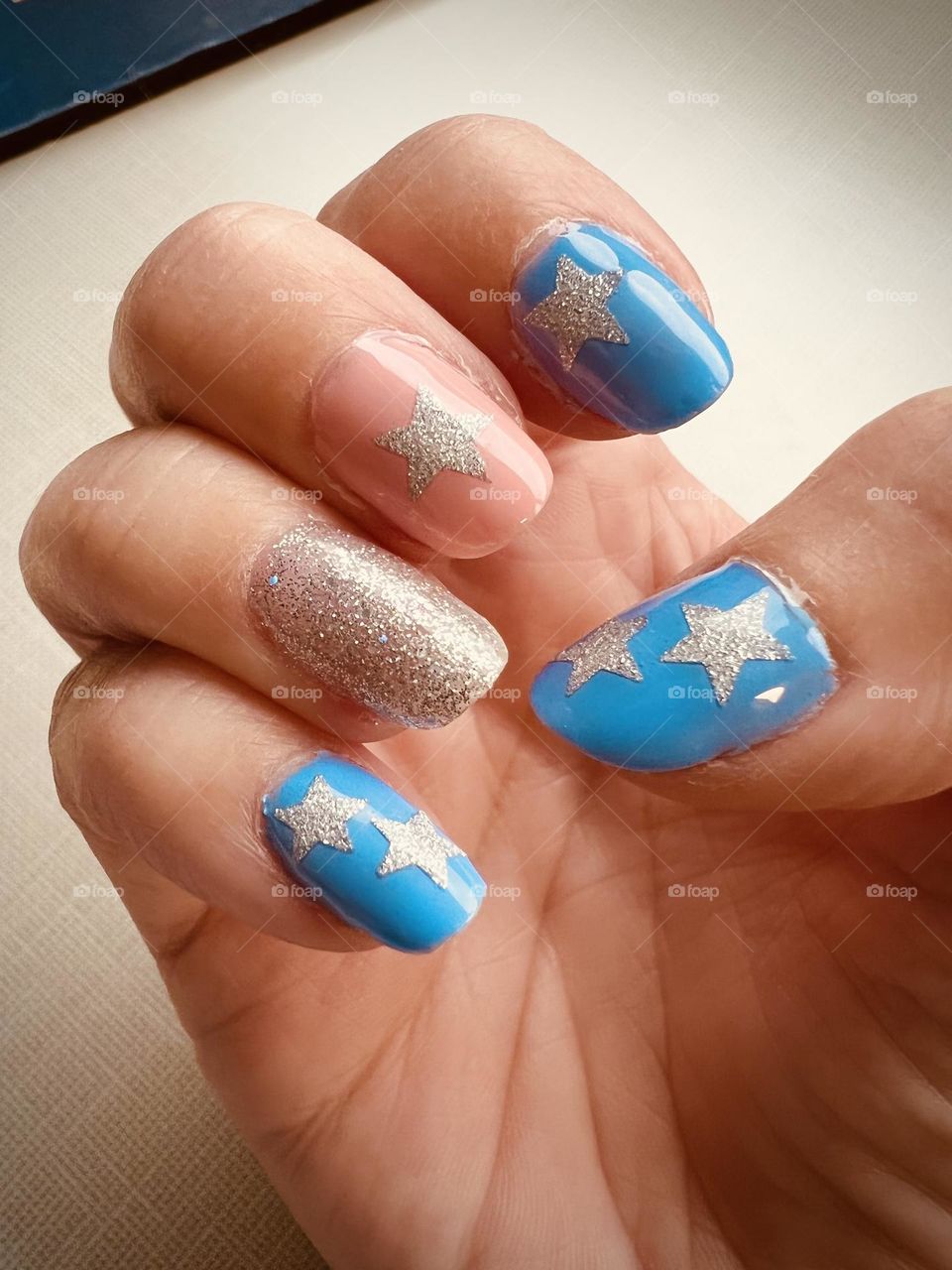 Pretty soft blue, peach and silver with stars nail art design 