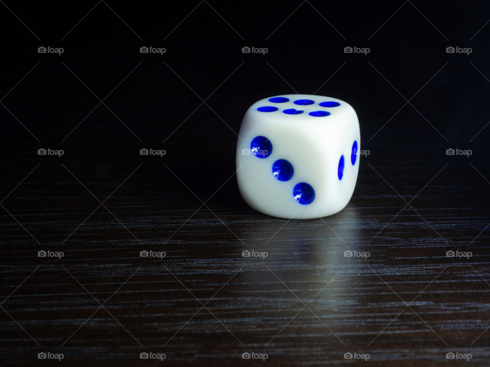 Table gambling with dice in the evening with dim light on a dark background