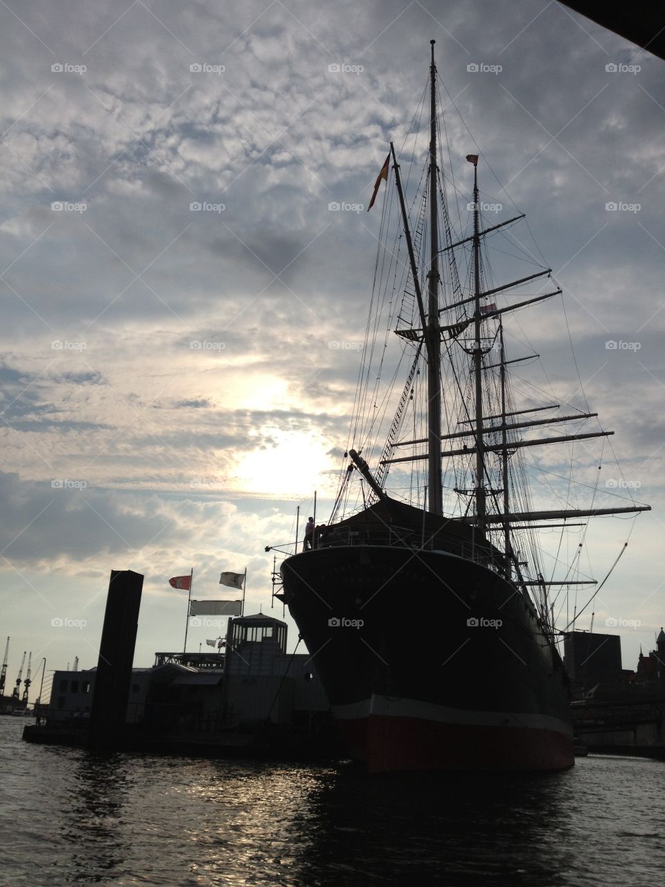 The silhouette of a ship docked in the harbor of Hamburg, Germany