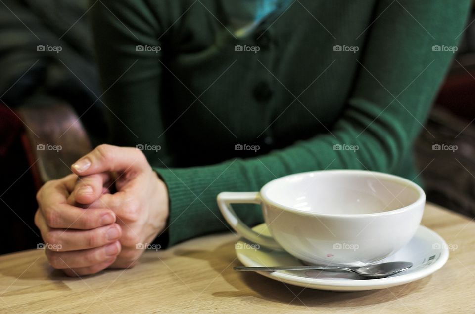 Tea cup and woman's hands. Empty tea cup and woman's hands