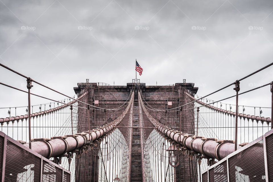 Dramatic landscape of the famous Brooklyn bridge in New York by an overcast day 