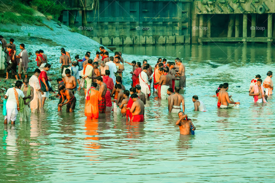 HARIDWAR, INDIA - JANUARY 14, 2016: Devotees taking holy dip at Har Ki Pauri on river Ganga on the first bath of Ardh Kumbh fair. People took a dip in holy Ganges on the occasion of Makar Sankranti