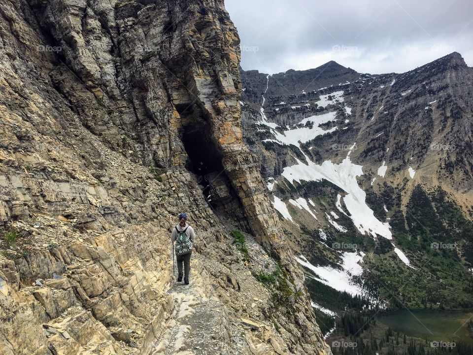  Hiking near the steep edge of a cliff while hiking the Crypt Lake Trail in Waterton Lakes National Park