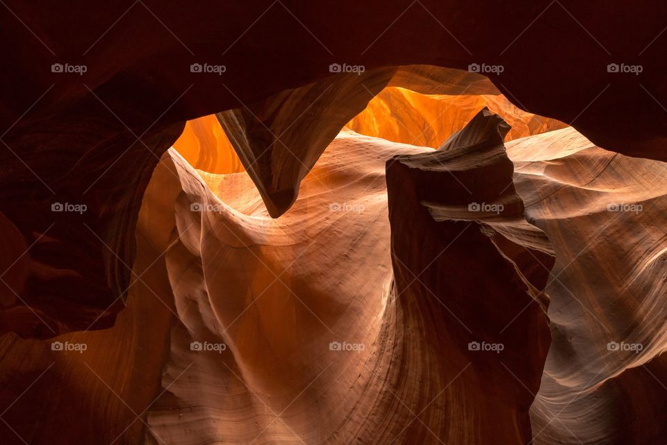 Looking up in Antelope canyon. Looking up towards the light in famous Antelope slot canyon. Smooth shapes created to red sand stone by water erosion