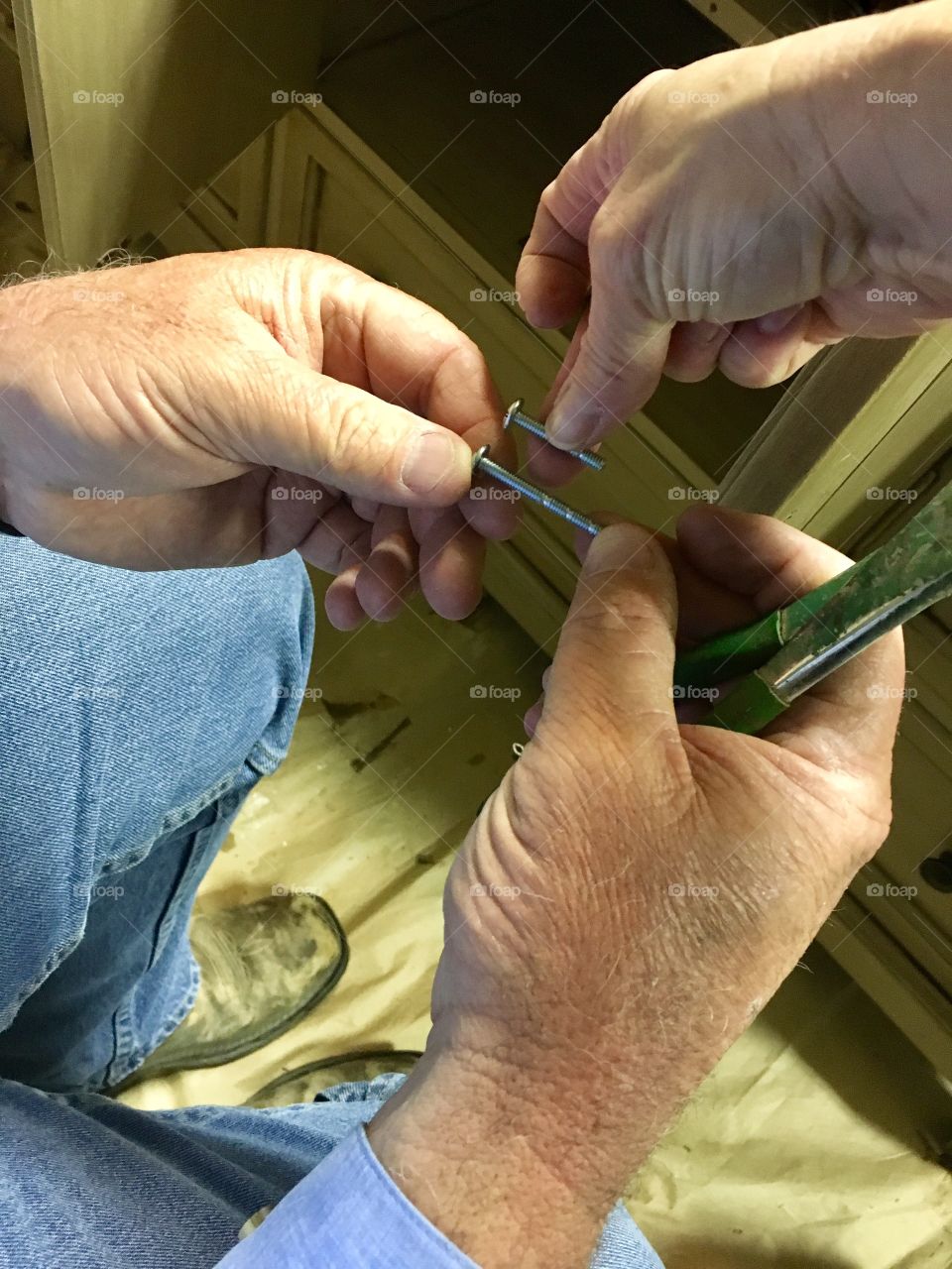 Putting hardware back on cabinet after refinishing 