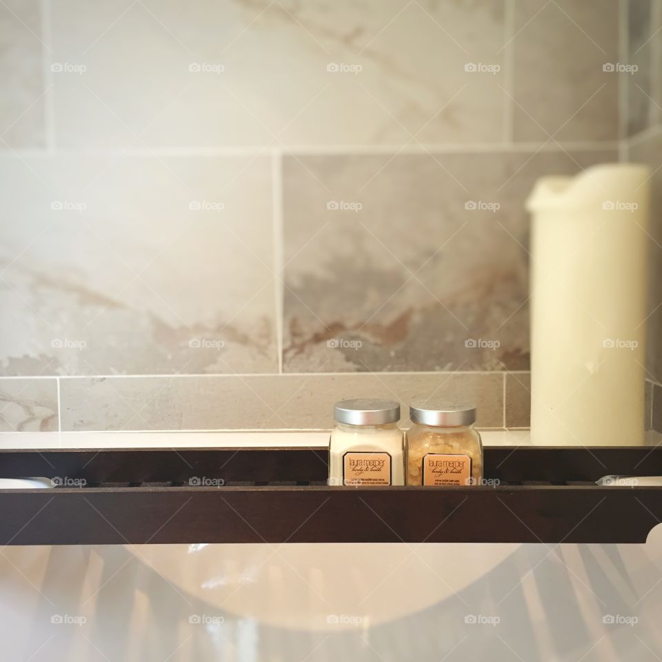 Bath shelf with candle and pots. 