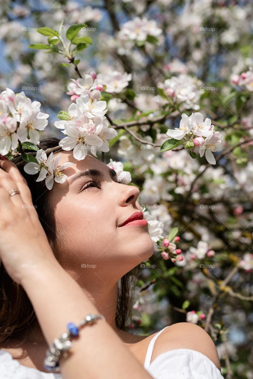 beautiful woman in spring blossom trees