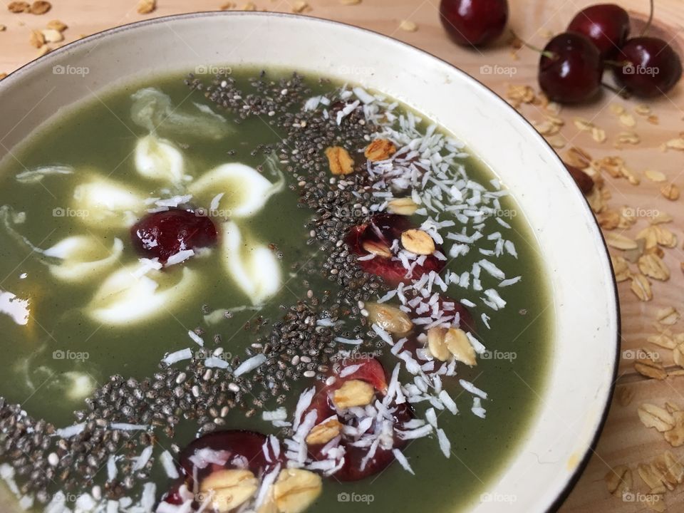 Cherry blossom green fruit smoothie bowl with creamy yogurt, chia, coconut, kiwi, dark red cherries and granola zen floral food design gourmet artisanal food photography 