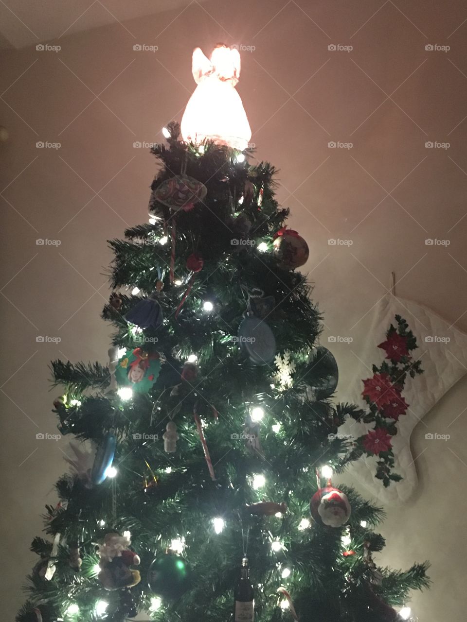 Lit Christmas tree and a stocking 