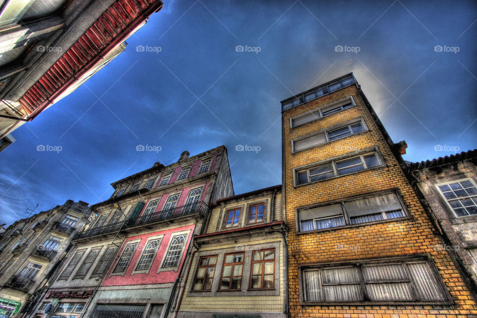 Low angle view of buildings against cloudy sky