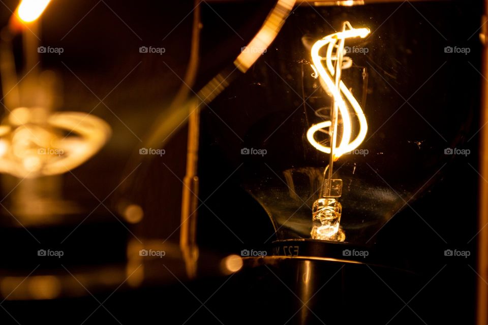 Extraordinary lamp reflects on a mirror. Swirly and bright it is.