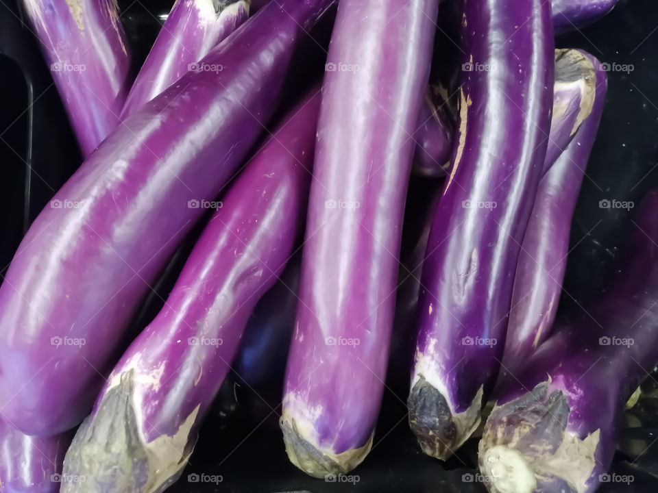 Bulk purple eggplants in a box