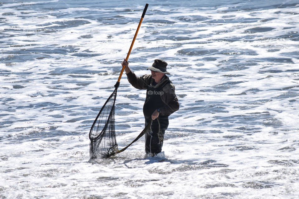 A man catching fish in the ocean