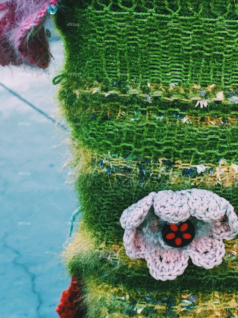 Crocheted flower on knitted background