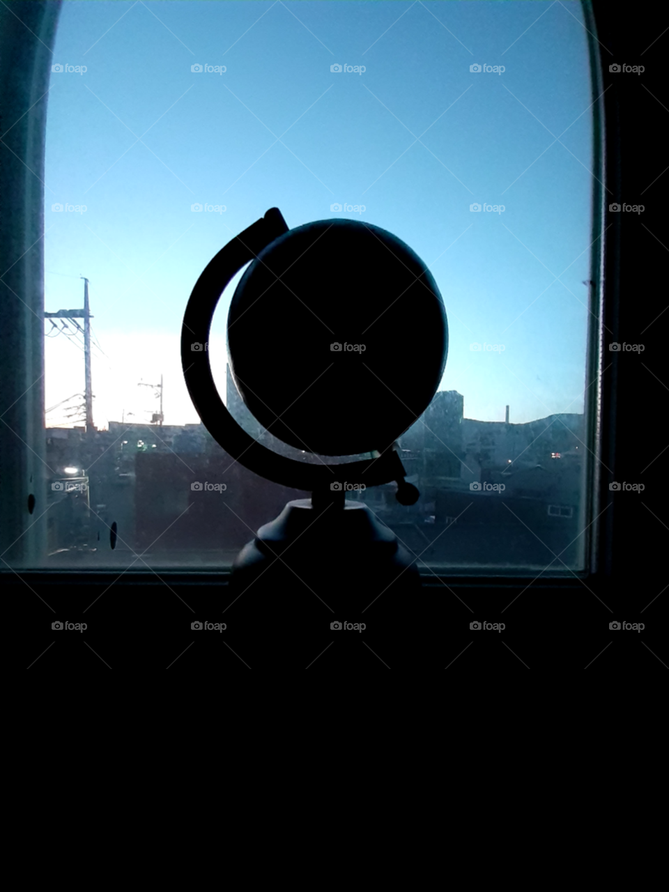 the shadow of the globe. its early morning  before sun rises. the little light outside the window help me make a shadow.