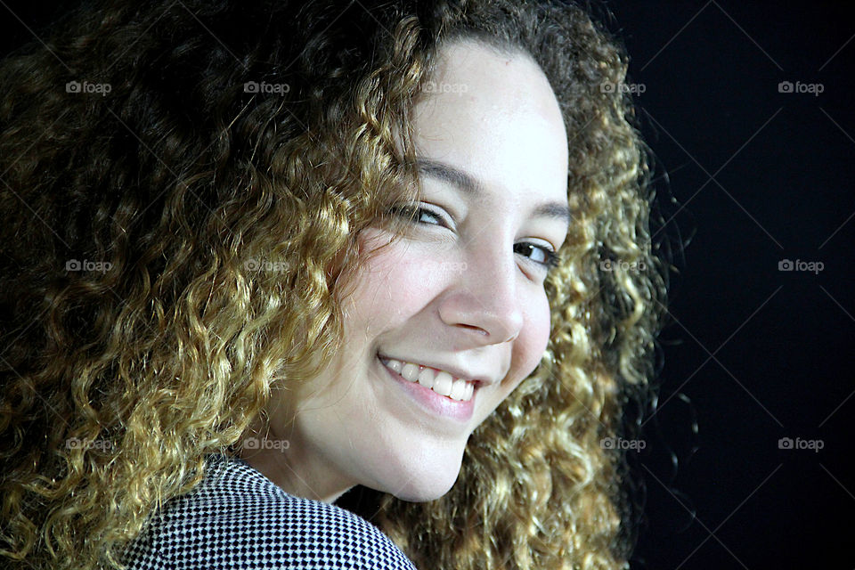 Portrait of blonde girl with curly hair.