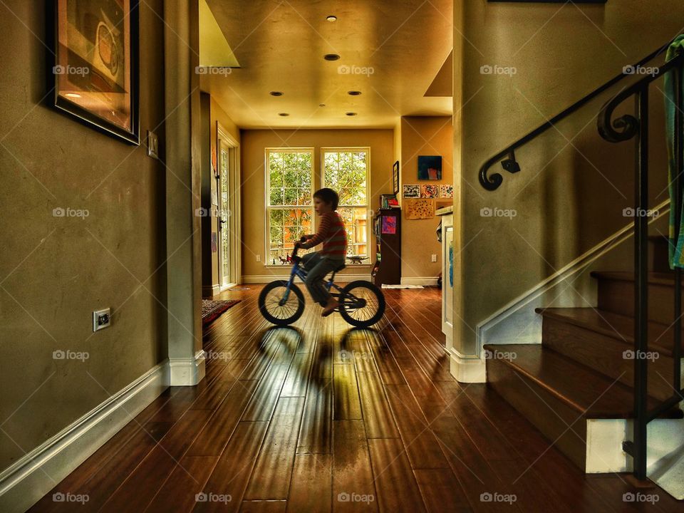 Child riding bike indoors
