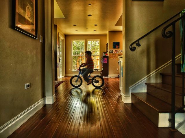 Child riding bike indoors