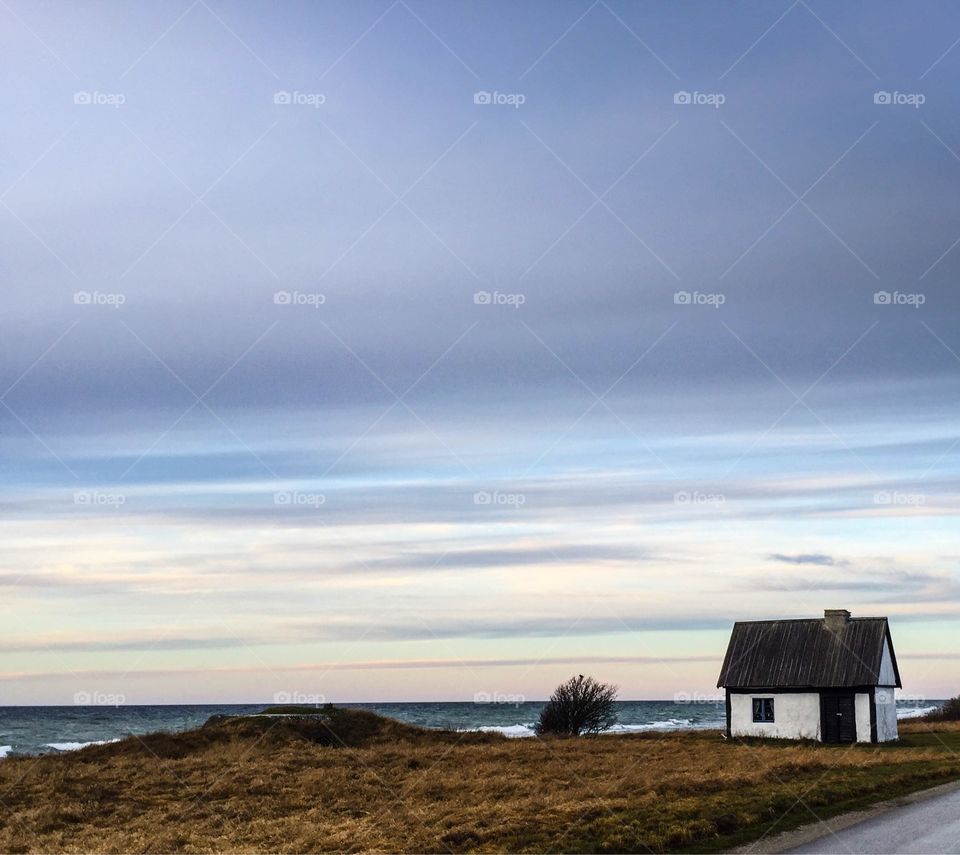 Small house by the sea. Coastal cottage. Island life. Off-season. Sunset. Sky. Scenery. Nordic. Gotland. Sweden. 