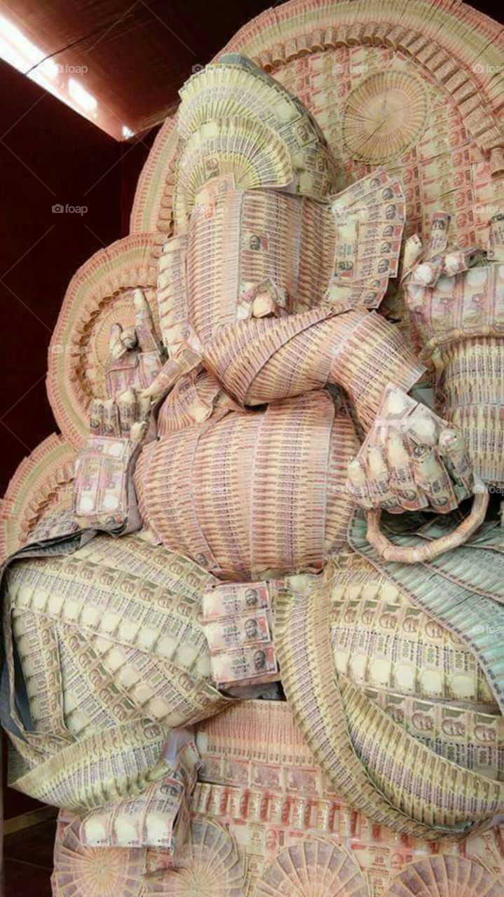 Indian God ganesh which is made up of Indian currency