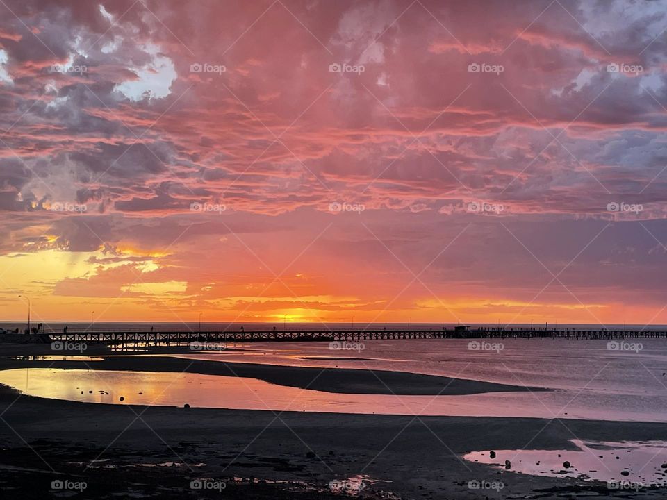 A sunset over a jetty 