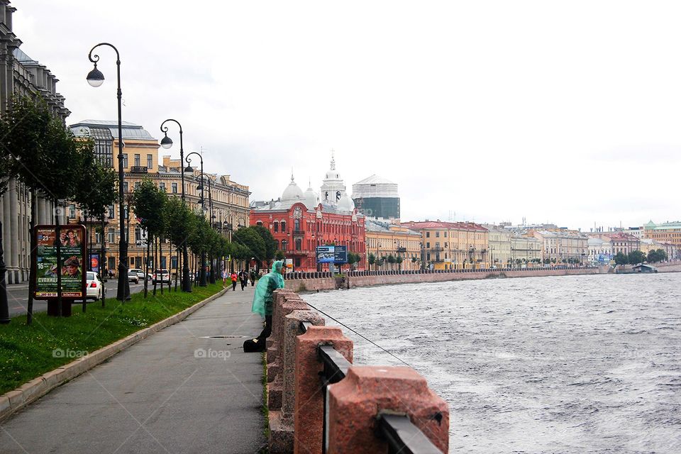 Portrait of a fisherman on a rainy day on the embankment of Neva, Saint Petersburg
