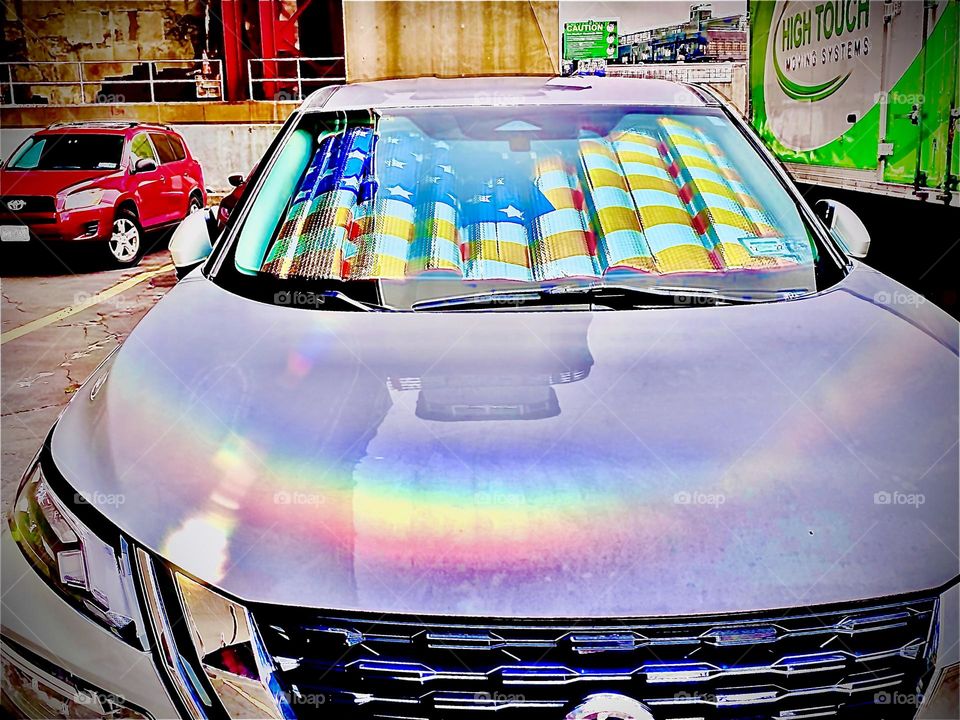 A white car with a metallic lamé coated plastic blowup pillow  lining its rear window „caught my eye“ in the parking lot beneath the Pulaski Bridge in LIC, Queens, NY   today on January 3rd, 2022. Hypnotic Productions