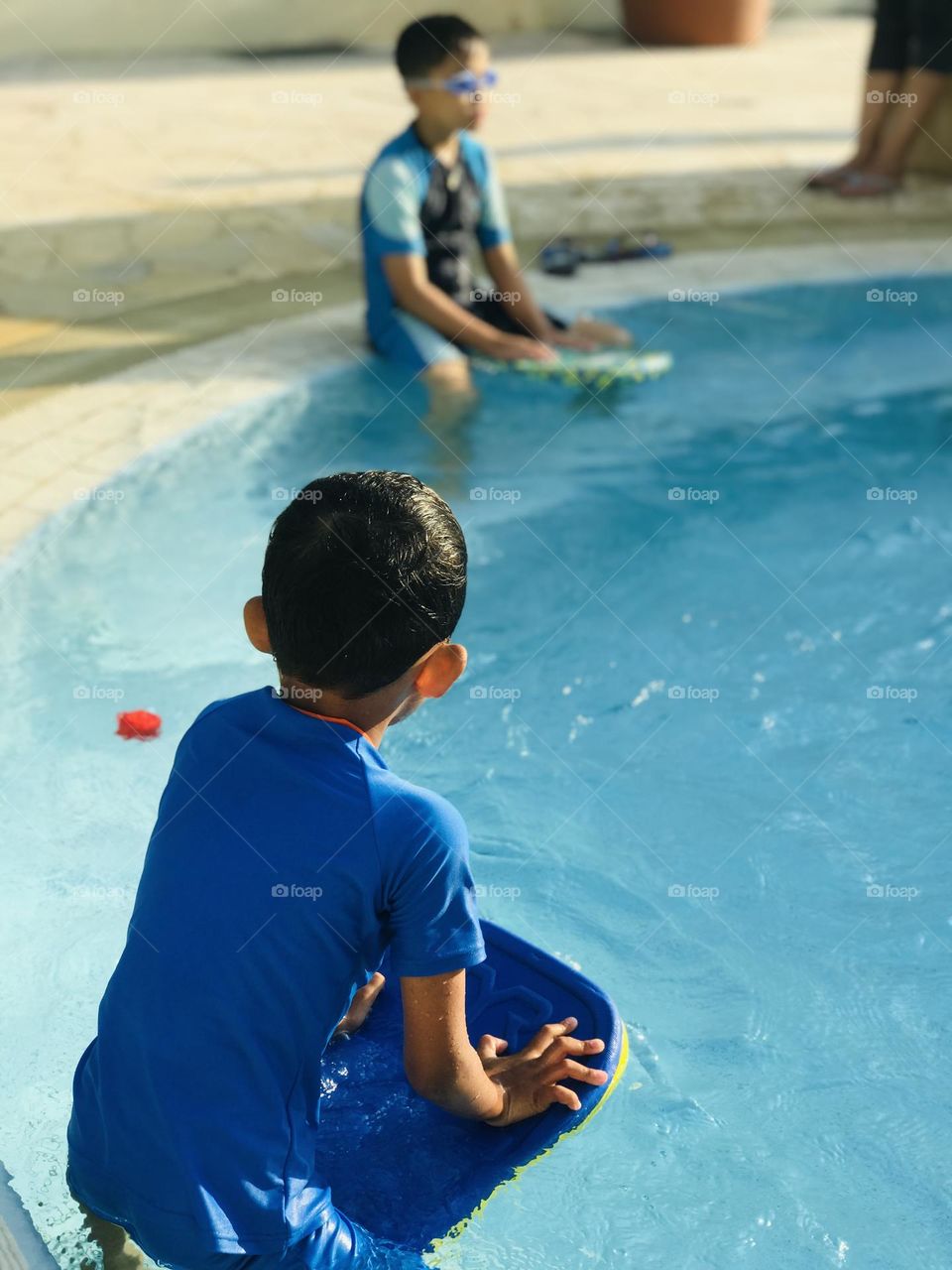 Kids are playing at swimming pool in summer with swimsuit’s 