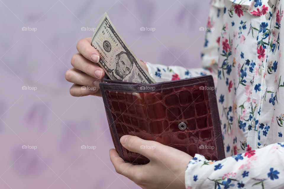 girl holding a purse with money