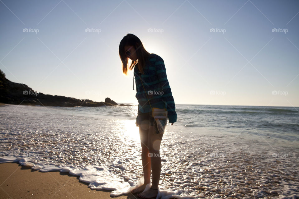 morning walk, Silhouette of Girl in shore of Coffs Harbour beach, NSW, Australia