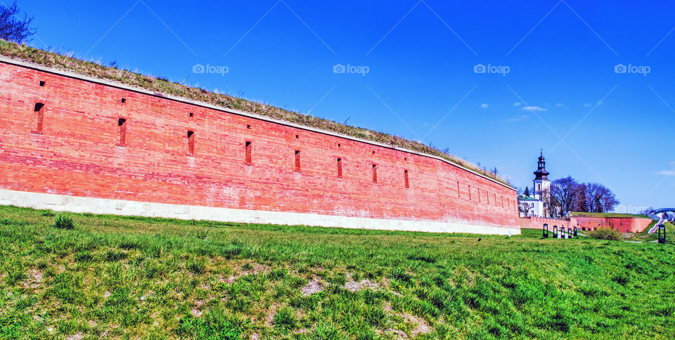 Built structure on field against blue sky.
