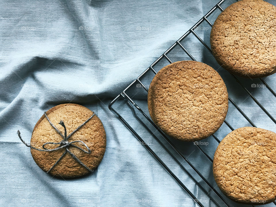Fresh baked homemade round cookies on rustic textile background 