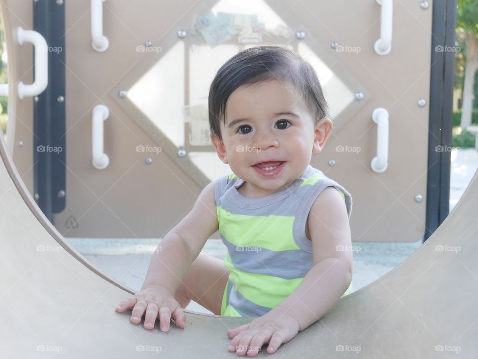 Sweet baby boy playing in play ground